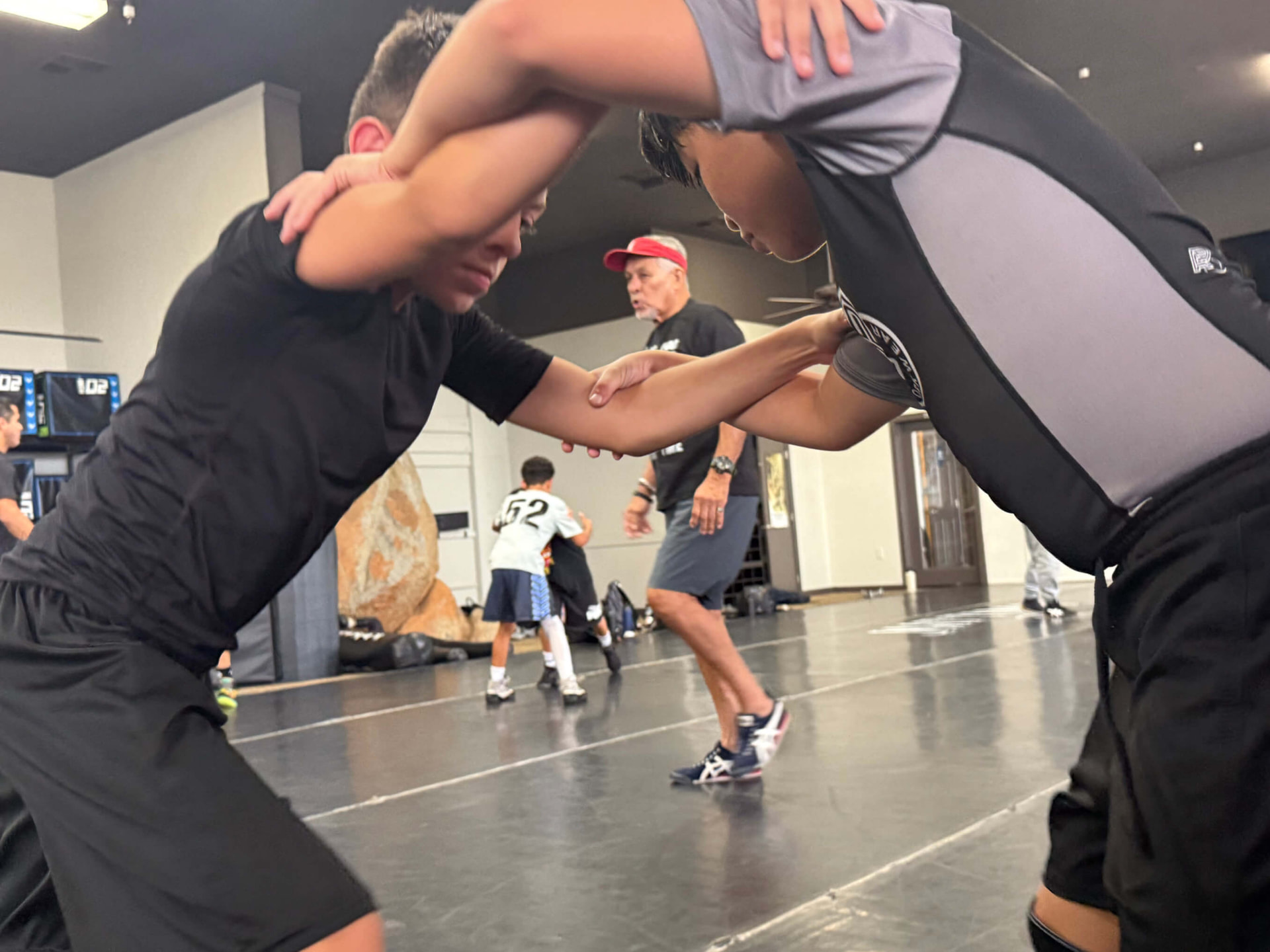 Wrestlers setting up a shot during MatTime practice