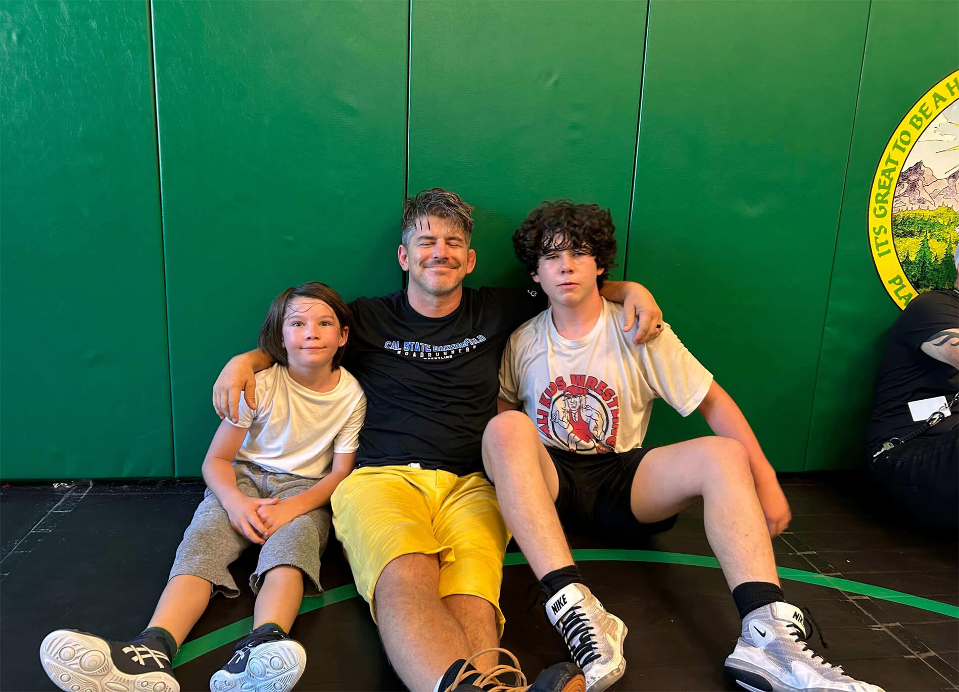 Coach Matt Sanchez with young wrestlers at Placer