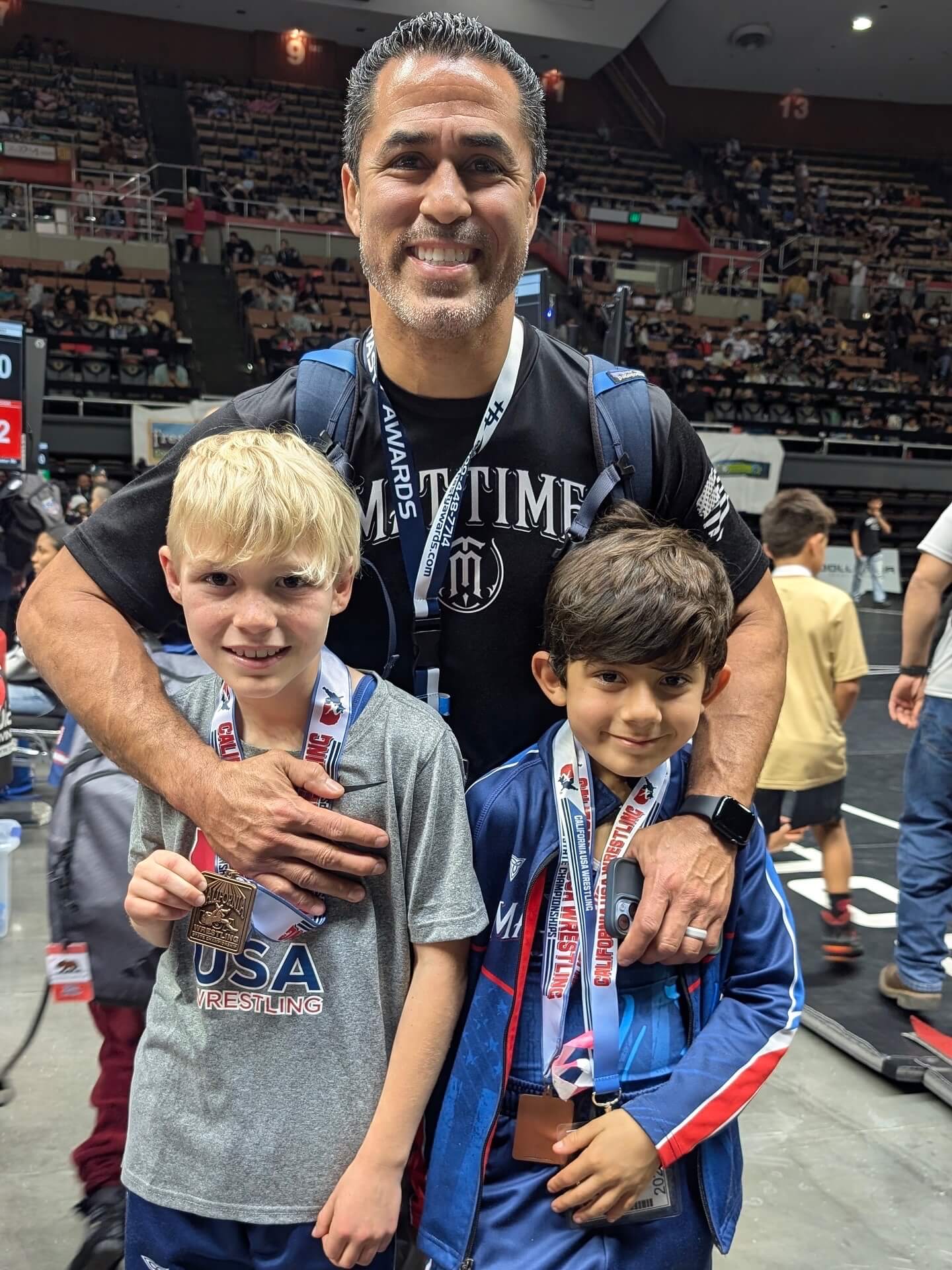 Coach Adrian Garcia with MatTime wrestlers at the California USA Wrestling State Championships