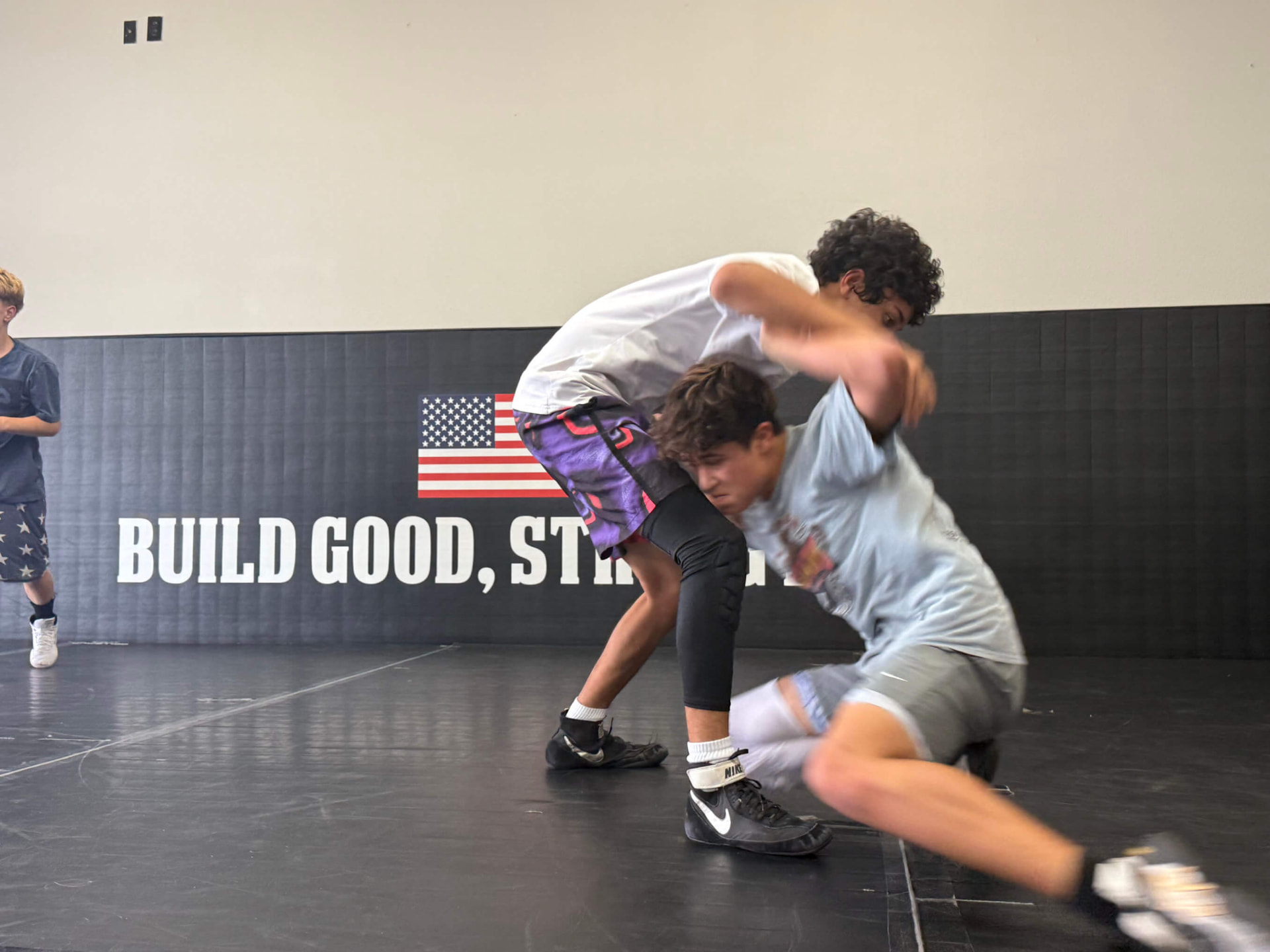 Wrestler ducking under for a takedown at MatTime