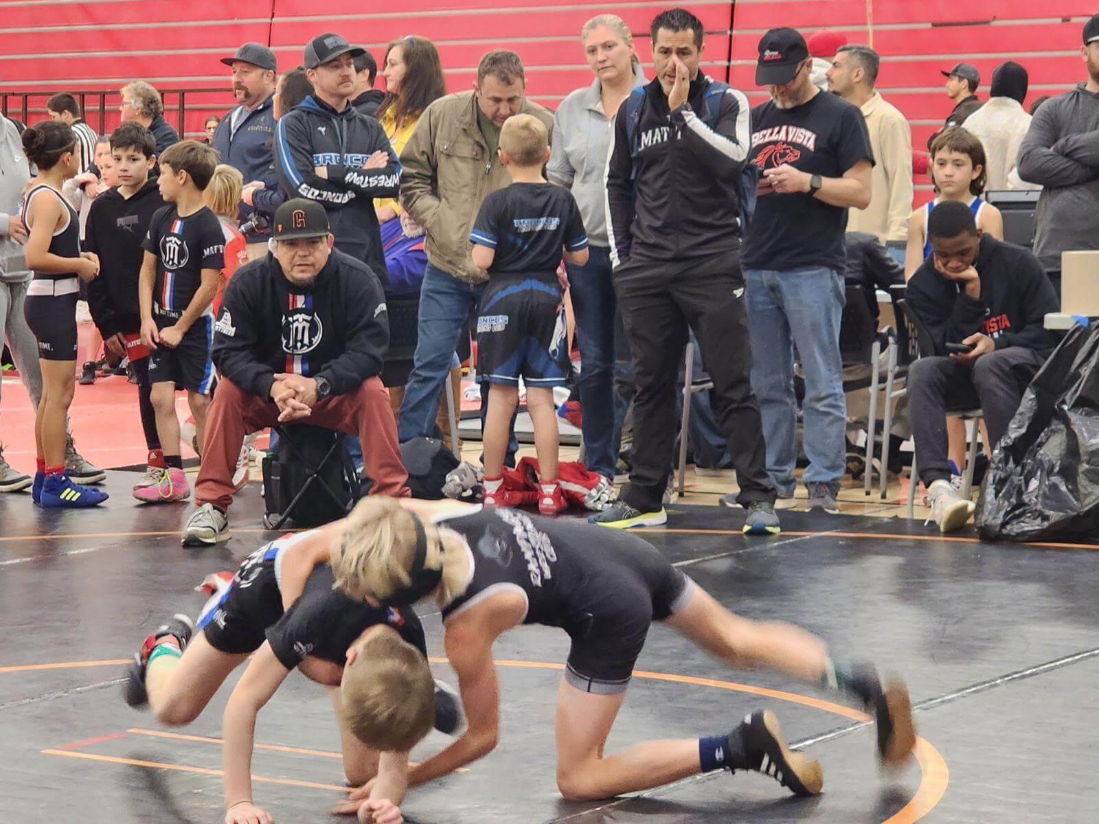 Coach Adrian Garcia coaching MatTime wrestlers at a tournament