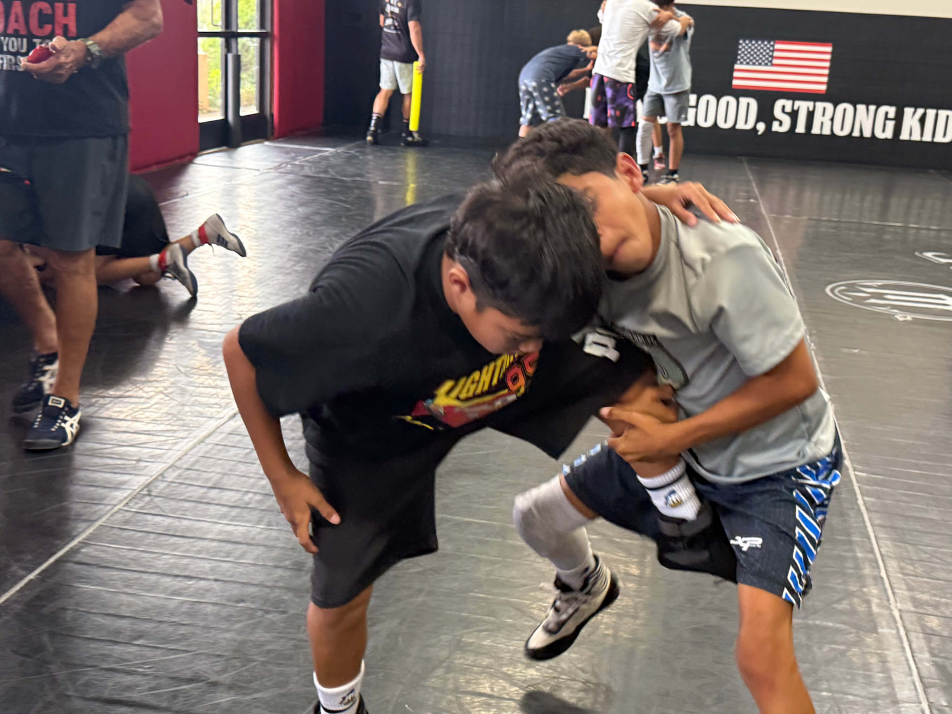 Wrestler finishing a hard single leg at MatTime
