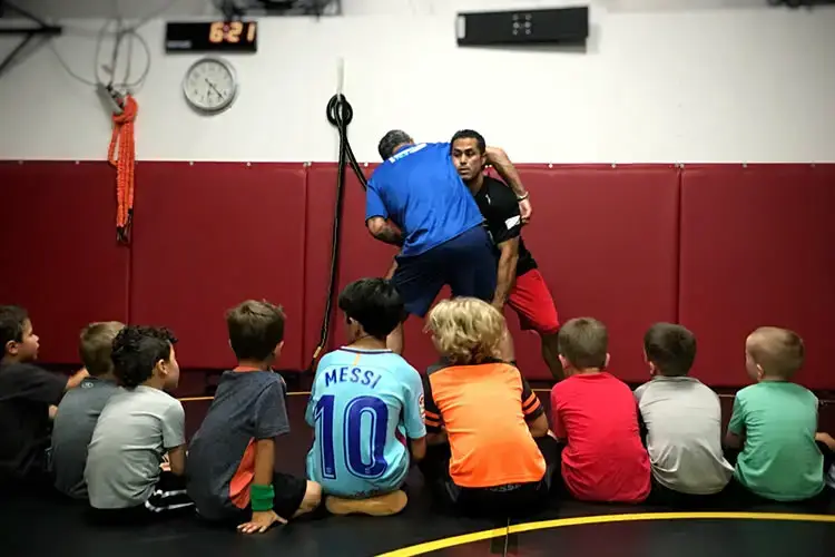 Adrian coaching kids wrestling